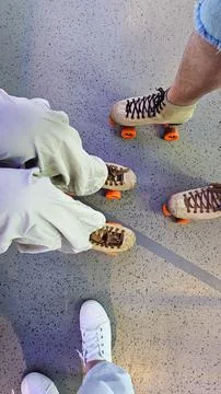 Two friends are roller skating on a smooth surface, enjoying a fun and active Foto stock