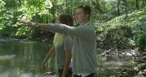 Two Friends Are Standing On A Stone By The River In The Forest Stock Footage 112294125