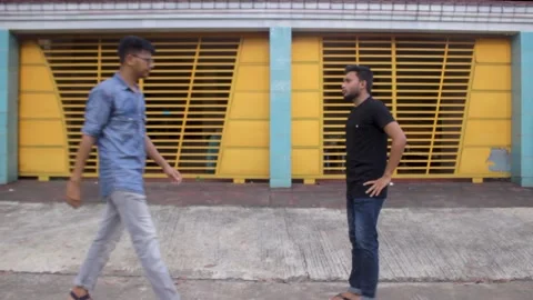 Two friends are talking next to the house on the road Stock Footage 296241033