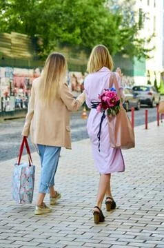 Two friends are walking down the street. Stock Photos