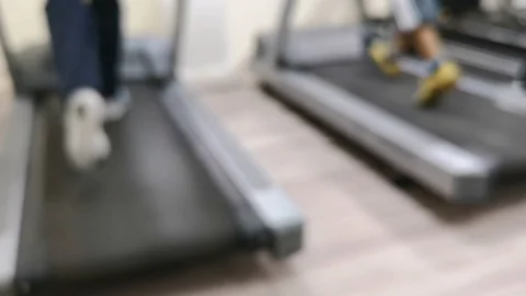 Two friends are working out to maintain their health by running on the treadmill Stock Footage 126078596