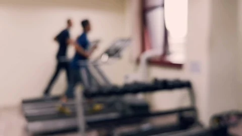 Two friends are working out to maintain their health by running on the treadmill Stock Footage 126081548