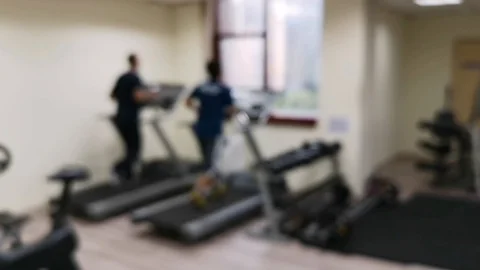 Two friends are working out to maintain their health by running on the treadmill Stock Footage 126081565