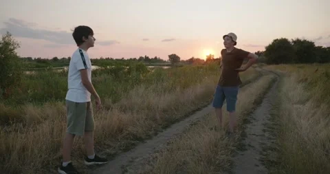 Two friends boys do exercise workout on nature. Teenage kids spend time together Stock Footage 345252196
