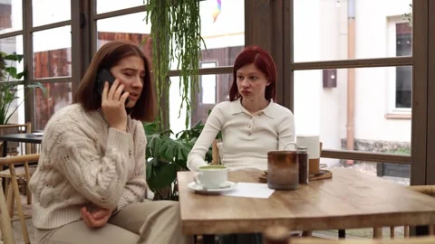 Two friends in a cafe receives shocking news  Stock Footage 320827322