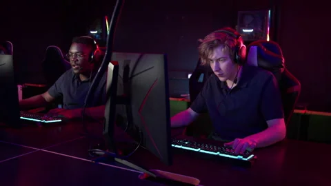 Two friends came in the evening to play in a computer club, they play Stock Footage 151500992