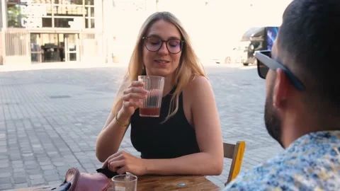 Two friends chat over coffee on a terrace. Barcelona, Spain Stock Footage 157004976