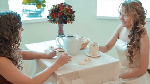 Two Friends Chatting While Drinking Cup of Tea Slow Motion Stock Footage 68689776