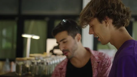 Two friends deciding which weed flowers buy in slow motion smiling Stock Footage 236457561