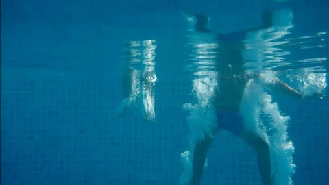 Two friends dive into the pool Stock Footage 79743808