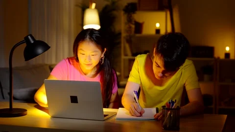 Two friends doing homework together Stock Footage 264931321