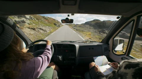 Two friends drive in camper van on epic road Stock Footage 242032215