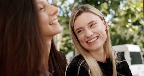 Two friends enjoy a conversation, looking at each other in love outside, summer Stock Footage 168255170