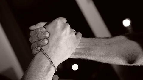 Two friends greet each other with a handshake. Dynamic beautiful frames. Stock Footage 124803574