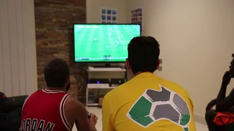 Two friends guys playing video game Stock Footage 79773218