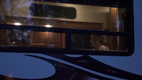 Two Friends Hang out in a 5th Wheel Camper on Vacation Stock Footage 80533799