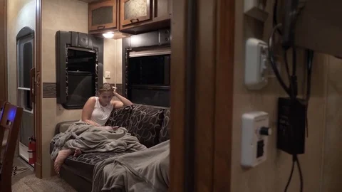 Two Friends Hang Out on Sofa inside 5th Wheel Toy Hauler Stock Footage 80539869