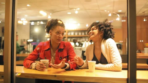 Two friends have a great time laughing together over a cup of coffee Video stock 34002937