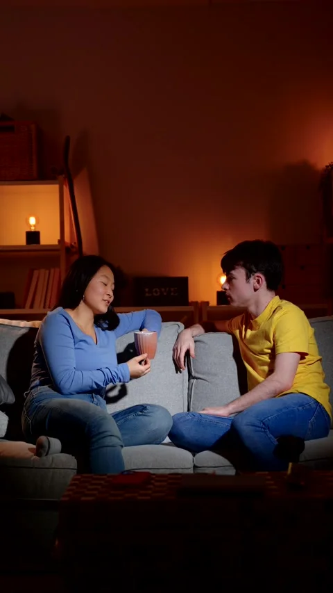 Two friends having conversation on sofa 스톡 동영상 263929962