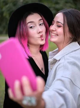 Two friends having fun taking a selfie doing lip gestures Stock Photos