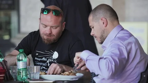 Two friends having lunch at restaurant Stock Footage 84000115