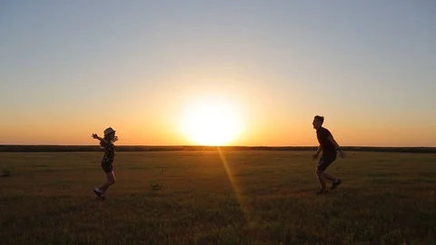 Two friends hold hands and back in circles on a beautiful summer day at sunset Stock Footage 89708955