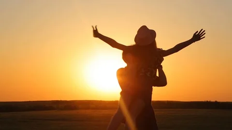 Two friends hold hands and back in circles on a beautiful summer day at sunset Stock Footage 89709080