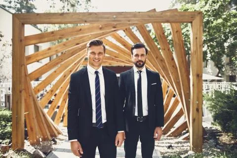 Two friends looking calm while standing outdoors together Stock Photos