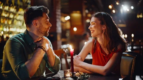 Two friends looking menu in dark cafe interior closeup. Happy couple discussing Vídeo Stock 334005974