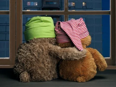 Two friends looking out the window at the windows of the house. Toys colorful Stock Photos