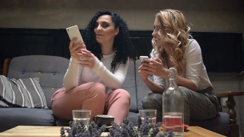 Two friends looking at the phone and laughing. Shopping online in cafe Video stock 105227301
