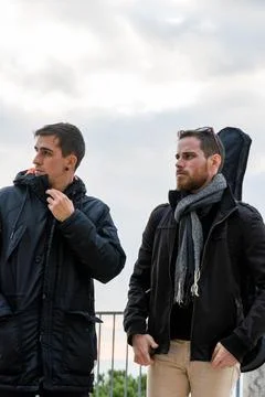 Two friends looking to the side surprised at the city viewpoint. Lifestyle .. Stock Photos
