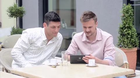 Two friends looking at tablet and talking Stock Footage 55819428