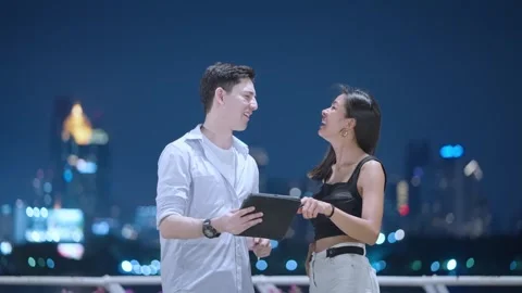 Two friends looking at tablet, tapping on touch screen having fun, urban people Stock Footage 276798837