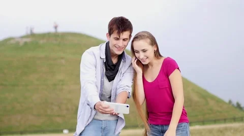 Two friends with mobile phone taking selfies.  Summer time. Video stock 53484502