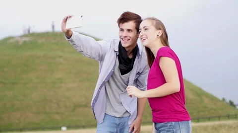 Two friends with mobile phone taking selfies.  Summer time. Stock Footage 55232776