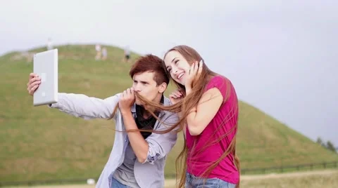 Two friends with mobile phone taking selfies.  Slow motion Stock Footage 55232875