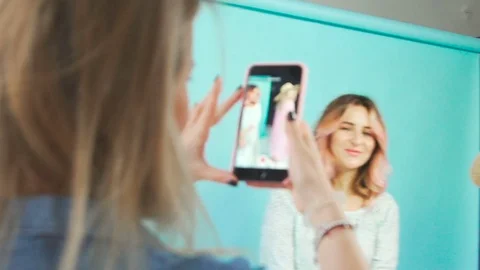 Two friends in a photo studio: one is posing, other is taking pictures 库存影片 76427557