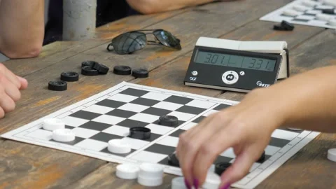 Two friends playing on checkers game Stock Footage 228882859