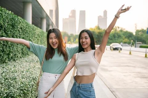 Two friends posing playfully in a cityscape of Bangkok Stock Photos