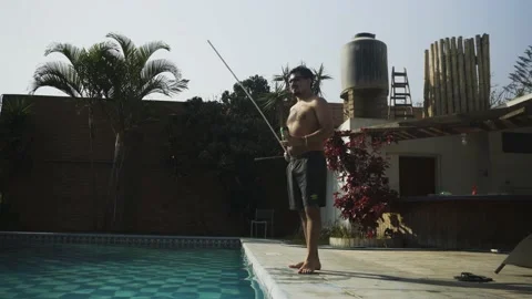 Two friends pretending to fish in a pool with each other (part 1 of 2). A man Stock Footage 170022561