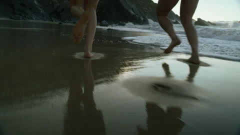 Two friends run barefoot on empty beach Stock-Footage 256916789