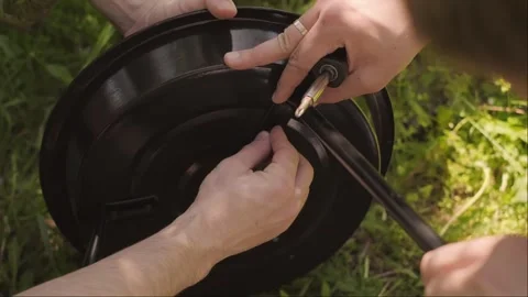 Two friends set up an eco friendly grill preventing direct fire contact with the Stock Footage 310741042