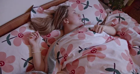 Two Friends Share a Restful Sleep in Cozy Matching Pajamas in a Serene Bedroom Video stock 313143401