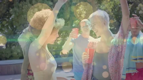 Two friends sharing glance, dancing on pool deck while group toasting, bokeh Stock Footage 333999735