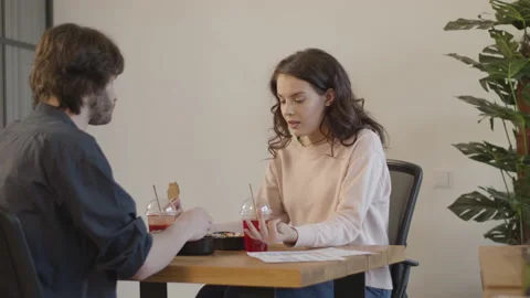 Two friends sharing their lunch and chatting in a cozy office Video stock 132924520