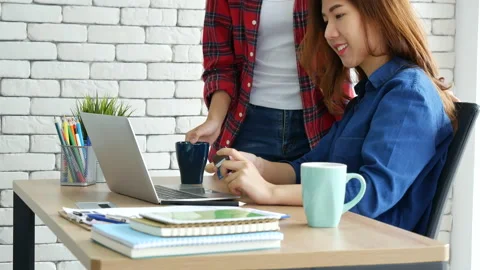Two friends shopping using credit card online shopping on website laptop e-comme Stock Footage 158071850