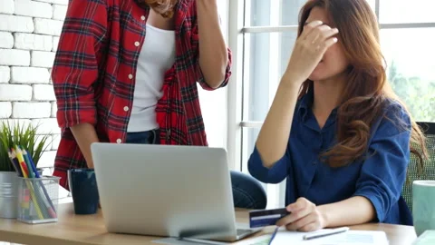 Two friends shopping using credit card online shopping on website laptop e-comme Stock Footage 158072485