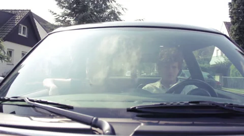 Two friends sitting in a car, driving through the neighborhood Stock Footage 41544448