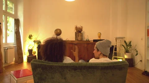 Two Friends Sitting on Sofa and Chatting Video stock 64964390